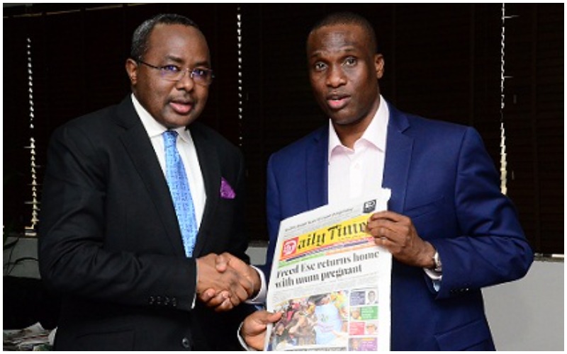 Fidelis Anosike, presenting a copy of the Daily Times to Mounir Gwarzo, DG SEC